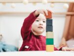 ABA Connect acquires Bright Behavior illustrated by young girl playing with blocks