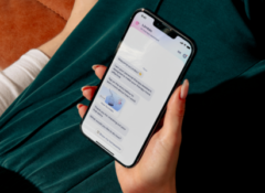 A person holds a cell phone showing a conversation with a Limbic AI chatbot.